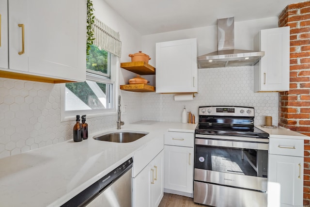 45 Coolidge Ave, Stamford, CT 06906 - kitchen featuring appliances with stainless steel finishes, wall chimney range hood, a sink, decorative backsplash, and white cabinets