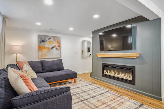 45 Coolidge Ave, Stamford, CT 06906 - living area featuring a glass covered fireplace, wood finished floors, recessed lighting, and baseboards