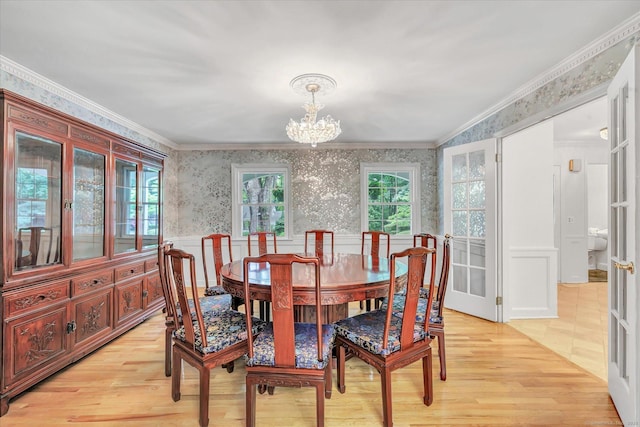 6 Cavray Rd, Norwalk, CT 06855 - dining space with wallpapered walls, crown molding, a chandelier, light wood-type flooring, and a wainscoted wall