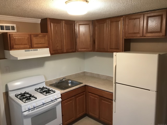 19 Outlook St, East Hartford, CT 06108 - kitchen with white appliances, under cabinet range hood, a sink, brown cabinetry, and a textured ceiling