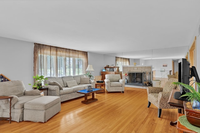 9 Marion Ct, North Haven, CT 06473 - living room featuring light wood-style flooring and a stone fireplace