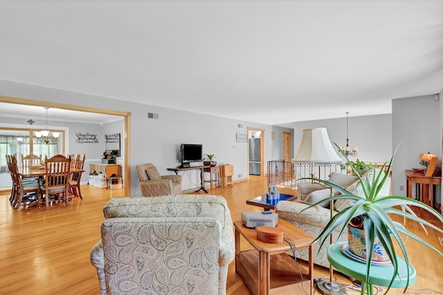 9 Marion Ct, North Haven, CT 06473 - living area featuring a chandelier and light wood finished floors