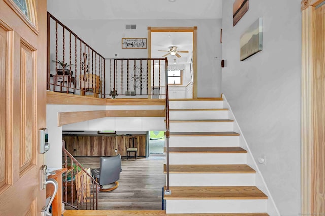 9 Marion Ct, North Haven, CT 06473 - stairway featuring a ceiling fan, wood finished floors, and a high ceiling