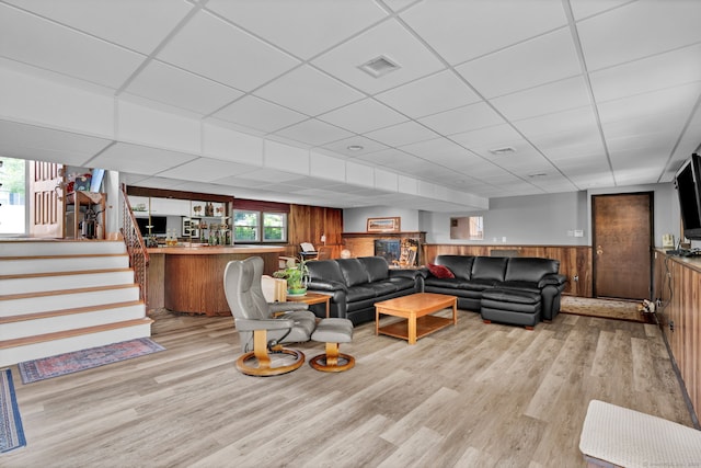 9 Marion Ct, North Haven, CT 06473 - living room featuring wood finished floors, wood walls, wainscoting, plenty of natural light, and stairway
