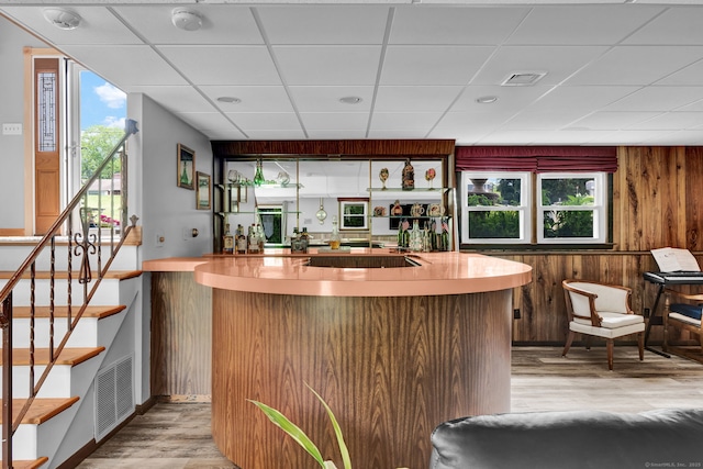 9 Marion Ct, North Haven, CT 06473 - community bar area with light wood finished floors, a paneled ceiling, healthy amount of natural light, stairs, and wood walls