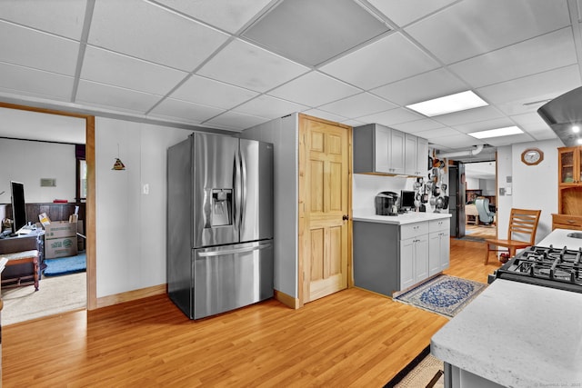9 Marion Ct, North Haven, CT 06473 - kitchen featuring stainless steel fridge, a drop ceiling, light wood finished floors, light countertops, and black range with gas stovetop
