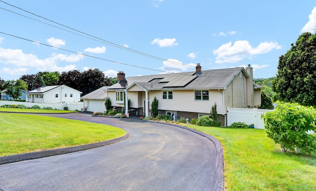 9 Marion Ct, North Haven, CT 06473 - split foyer home with roof mounted solar panels, a chimney, and asphalt driveway