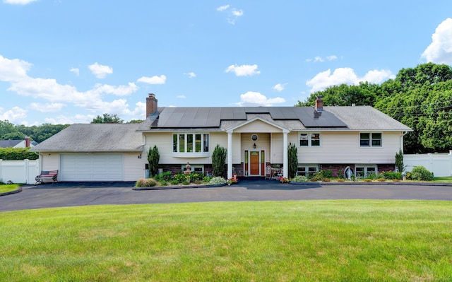 9 Marion Ct, North Haven, CT 06473 - bi-level home with a chimney, solar panels, a garage, and driveway