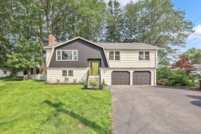 29 Magellan Dr, Milford, CT 06460 - raised ranch with driveway, a chimney, and an attached garage