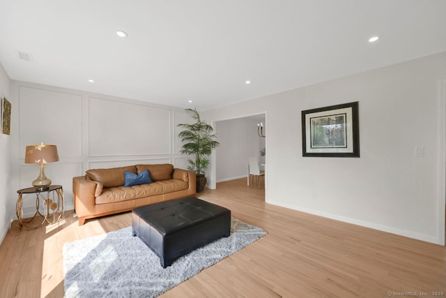 29 Magellan Dr, Milford, CT 06460 - living room featuring light wood-style flooring, recessed lighting, and a decorative wall
