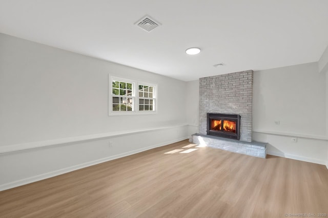 29 Magellan Dr, Milford, CT 06460 - unfurnished living room with a brick fireplace and wood finished floors