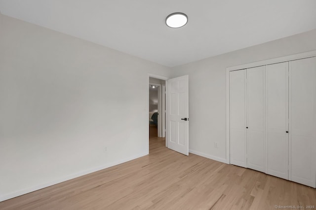 29 Magellan Dr, Milford, CT 06460 - unfurnished bedroom with light wood finished floors and a closet