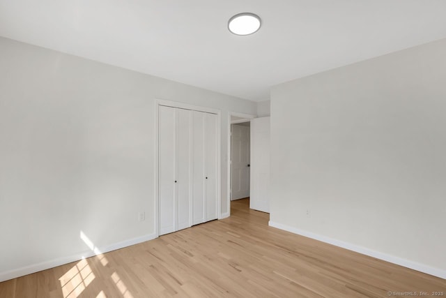 29 Magellan Dr, Milford, CT 06460 - unfurnished bedroom with light wood-type flooring and a closet