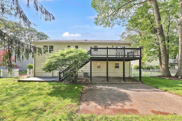 29 Magellan Dr, Milford, CT 06460 - back of house featuring a wooden deck, a patio, and asphalt driveway