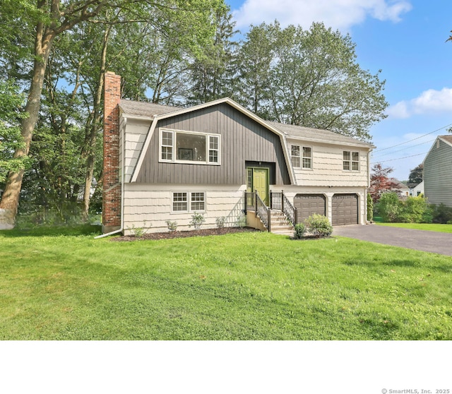 29 Magellan Dr, Milford, CT 06460 - bi-level home featuring a chimney, asphalt driveway, a garage, and a front lawn