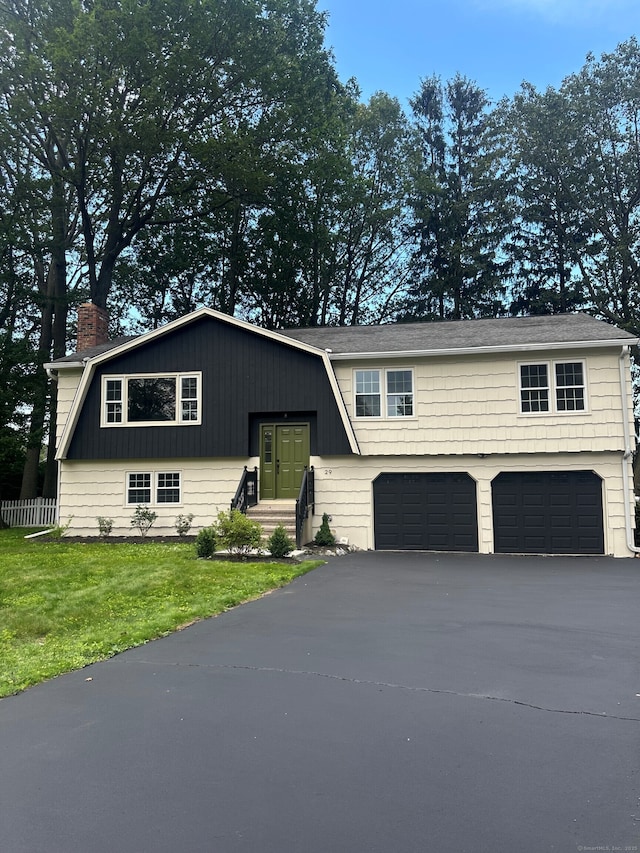 29 Magellan Dr, Milford, CT 06460 - bi-level home with an attached garage, asphalt driveway, and a chimney