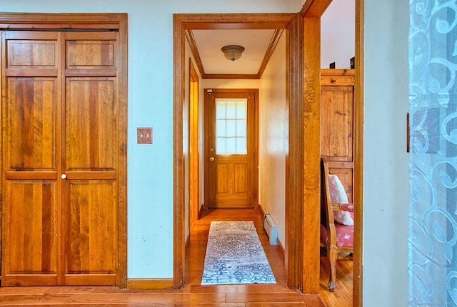 26 Lighthouse Hill Rd, Windsor, CT 06095 - corridor with baseboard heating, crown molding, wood finished floors, and baseboards