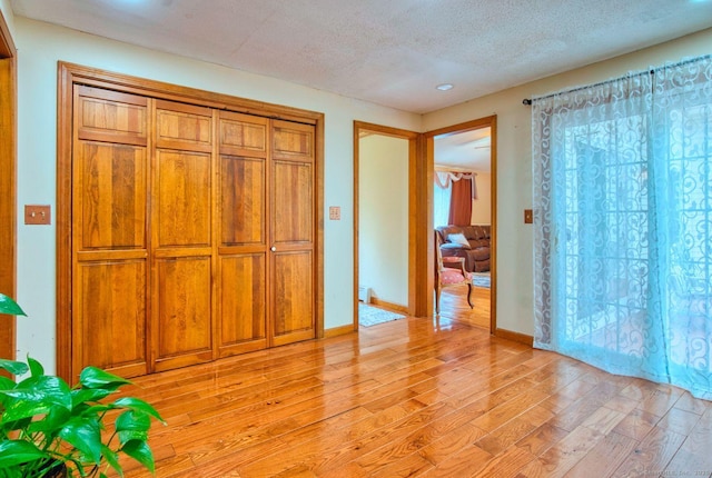 26 Lighthouse Hill Rd, Windsor, CT 06095 - unfurnished bedroom with light wood finished floors, a textured ceiling, baseboards, and recessed lighting