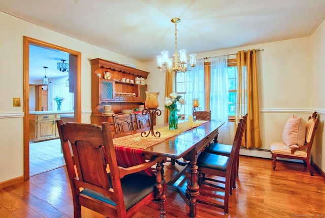 26 Lighthouse Hill Rd, Windsor, CT 06095 - dining space featuring a chandelier, light wood-style flooring, and a baseboard radiator