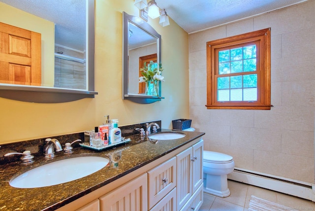 26 Lighthouse Hill Rd, Windsor, CT 06095 - bathroom with a baseboard radiator, tile patterned flooring, double vanity, toilet, and a textured ceiling