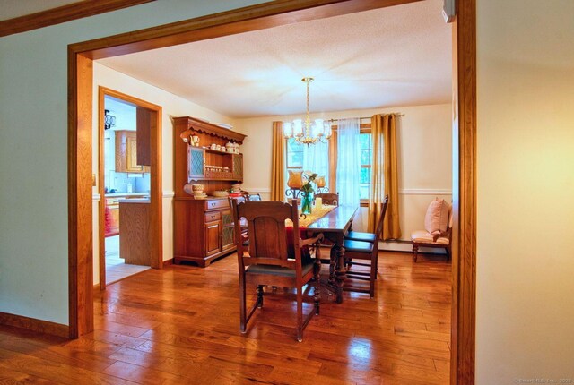 26 Lighthouse Hill Rd, Windsor, CT 06095 - dining area with a chandelier, hardwood / wood-style floors, and baseboards