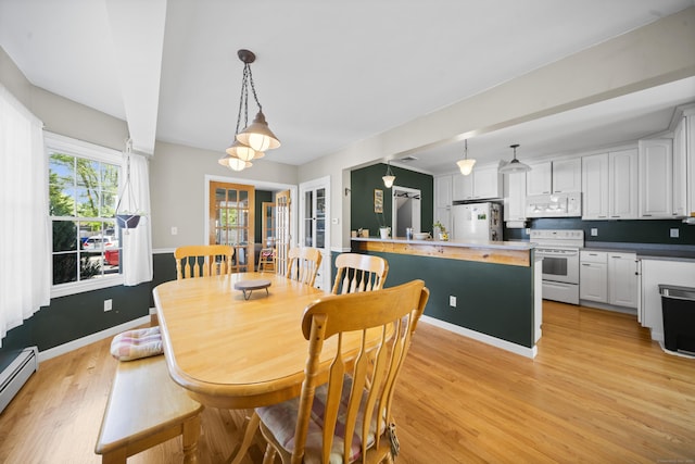 116 Grove St, Windsor Locks, CT 06096 - dining area with a baseboard radiator, light wood finished floors, baseboards, and french doors