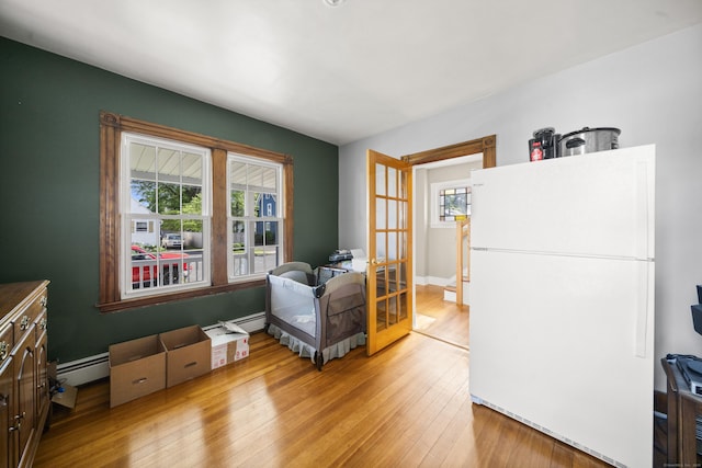116 Grove St, Windsor Locks, CT 06096 - sitting room featuring french doors, light wood-type flooring, and a baseboard radiator