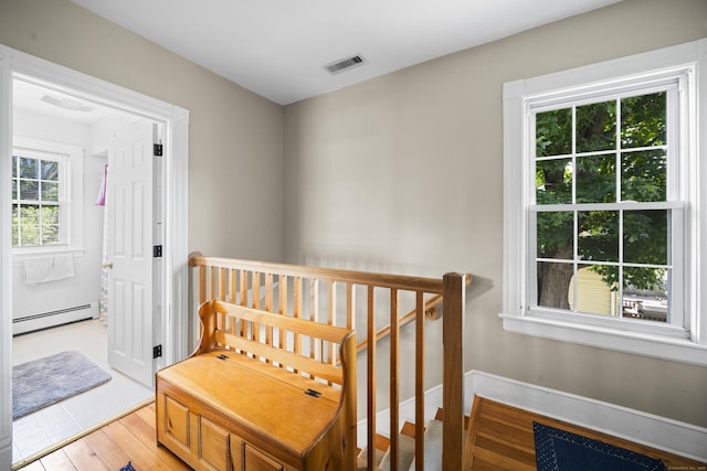 116 Grove St, Windsor Locks, CT 06096 - hall featuring a baseboard heating unit, an upstairs landing, and light wood finished floors