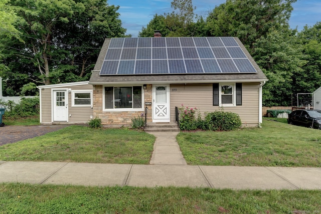 379 Belden Rd, Hamden, CT 06514 - view of front of house with a front yard, solar panels, a chimney, and a shingled roof