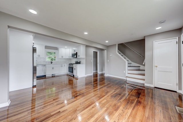 379 Belden Rd, Hamden, CT 06514 - unfurnished living room with light wood finished floors, stairs, baseboards, and recessed lighting