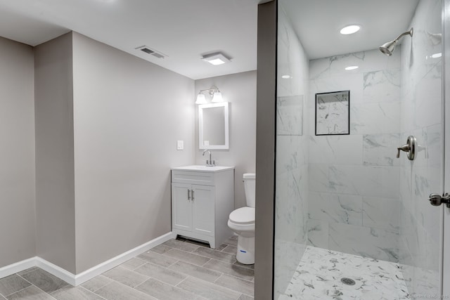 379 Belden Rd, Hamden, CT 06514 - bathroom featuring toilet, vanity, a tile shower, and baseboards