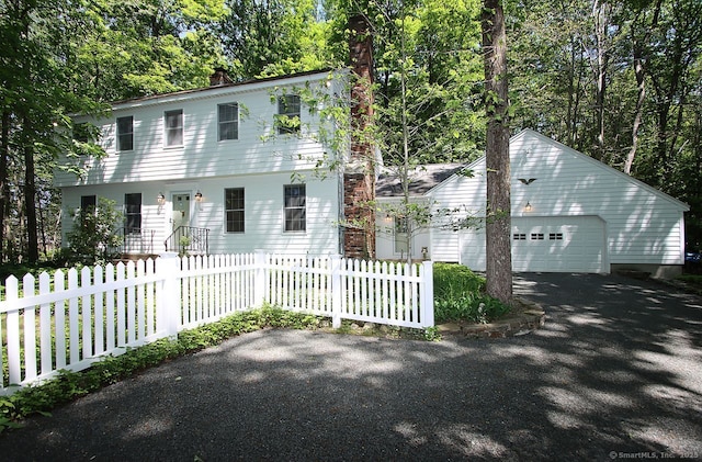 467 Weekeepeemee Rd, Woodbury, CT 06798 - colonial house featuring a chimney, a fenced front yard, a garage, and driveway