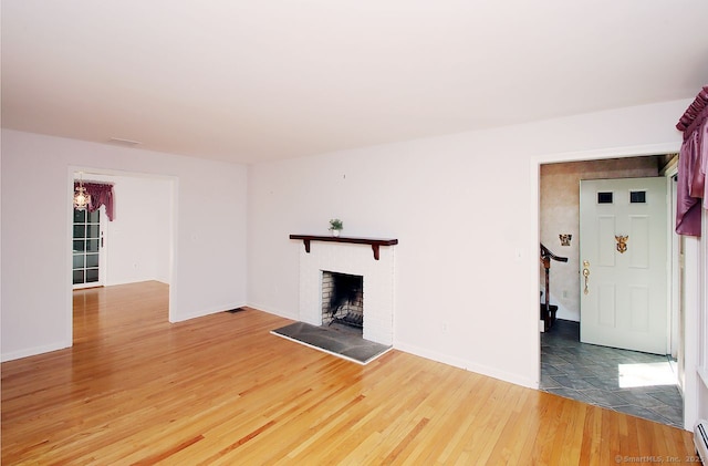 467 Weekeepeemee Rd, Woodbury, CT 06798 - unfurnished living room featuring light wood-type flooring, a brick fireplace, baseboards, and a baseboard heating unit