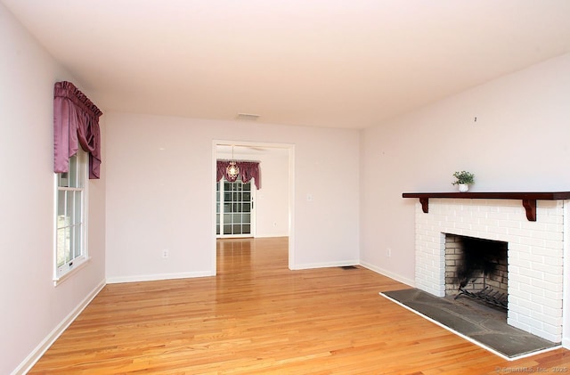467 Weekeepeemee Rd, Woodbury, CT 06798 - unfurnished living room featuring light wood-style flooring, plenty of natural light, a brick fireplace, and baseboards