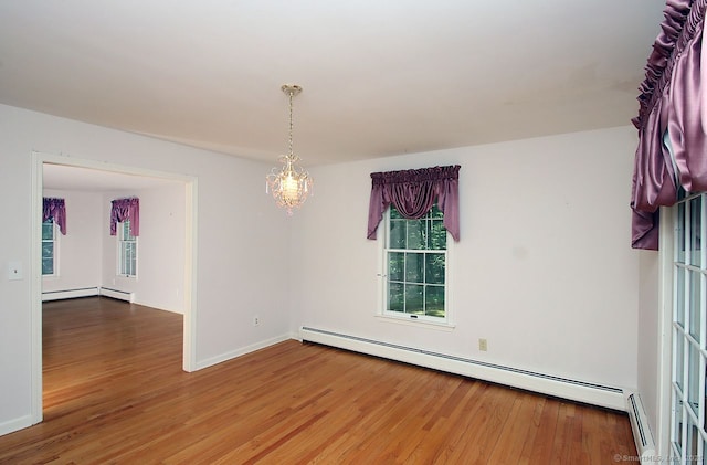 467 Weekeepeemee Rd, Woodbury, CT 06798 - spare room featuring a baseboard radiator, wood finished floors, plenty of natural light, and a chandelier