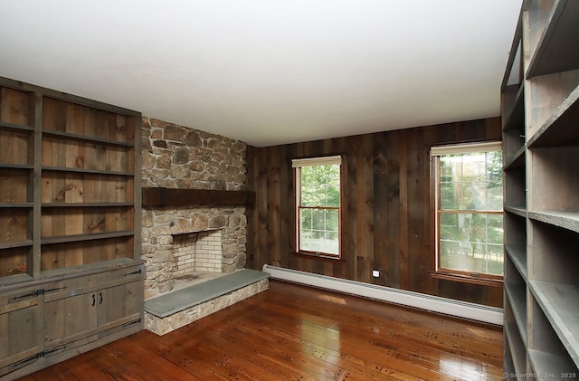 467 Weekeepeemee Rd, Woodbury, CT 06798 - unfurnished living room featuring baseboard heating, a fireplace, wood-type flooring, and wood walls