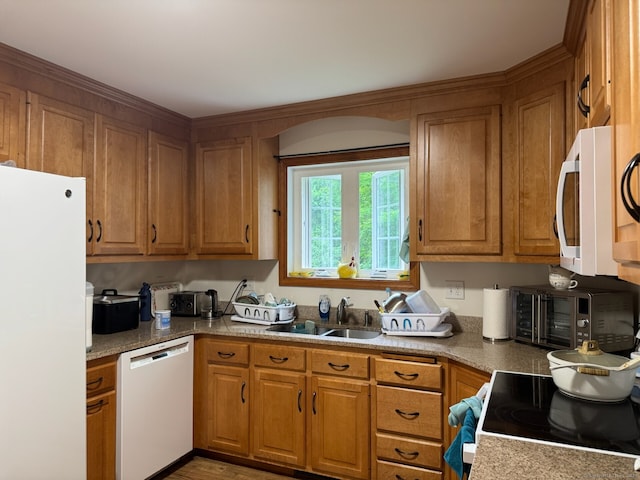 218 Fish Rock Rd, Southbury, CT 06488 - kitchen with white appliances, a sink, brown cabinetry, and light wood-style flooring