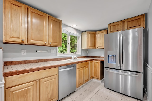 15 Indian Hill Rd, Canton, CT 06019 - kitchen featuring stainless steel appliances, a sink, light tile patterned floors, tile countertops, and light brown cabinetry