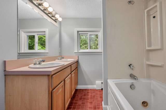 15 Indian Hill Rd, Canton, CT 06019 - bathroom featuring a jetted tub, baseboard heating, double vanity, and a textured ceiling