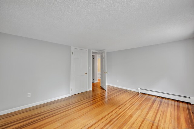 15 Indian Hill Rd, Canton, CT 06019 - spare room with a baseboard radiator, wood finished floors, a textured ceiling, and baseboards