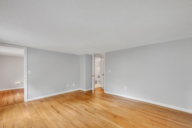 15 Indian Hill Rd, Canton, CT 06019 - unfurnished room with light wood-style flooring, baseboards, and a textured ceiling