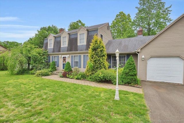 79 Carriage Dr E, Meriden, CT 06450 - view of front of house with a chimney, a gambrel roof, a garage, and a front lawn