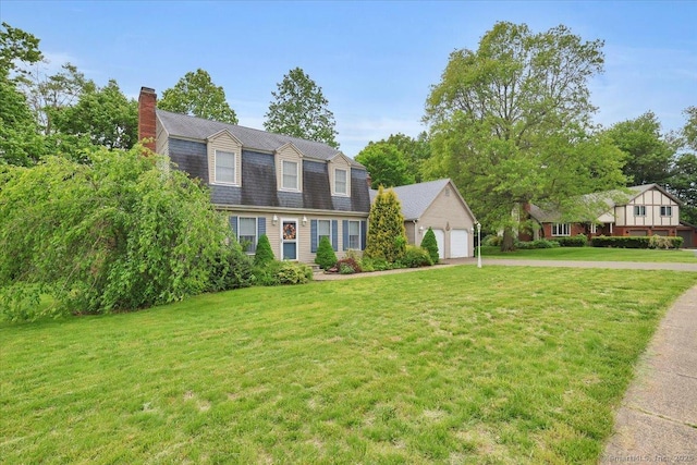 79 Carriage Dr E, Meriden, CT 06450 - dutch colonial with driveway, a chimney, a garage, and a front yard