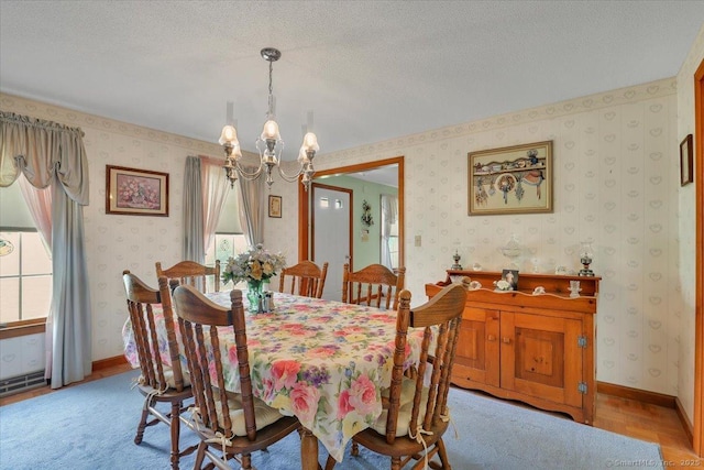 79 Carriage Dr E, Meriden, CT 06450 - dining space featuring a chandelier, wallpapered walls, and a textured ceiling