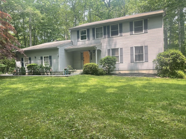 colonial-style house with a front lawn