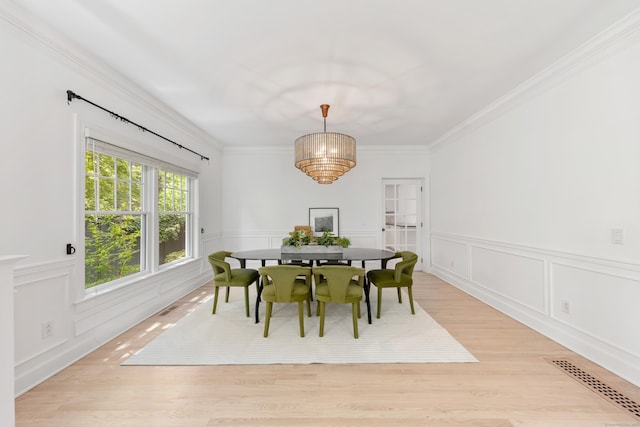 31 Pleasant St, Darien, CT 06820 - dining room featuring wainscoting, light wood-type flooring, a decorative wall, ornamental molding, and a chandelier