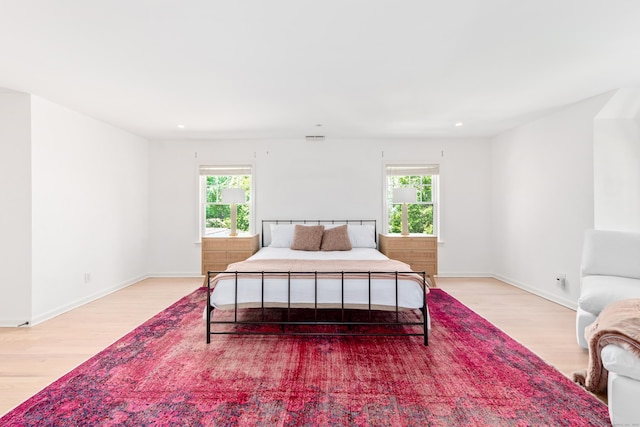 31 Pleasant St, Darien, CT 06820 - bedroom with light wood-type flooring, multiple windows, baseboards, and recessed lighting