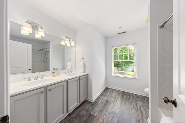 31 Pleasant St, Darien, CT 06820 - bathroom featuring double vanity, toilet, wood finished floors, and baseboards