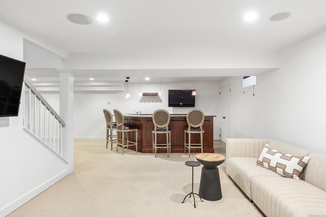 31 Pleasant St, Darien, CT 06820 - living area with wet bar, crown molding, baseboards, light carpet, and stairs