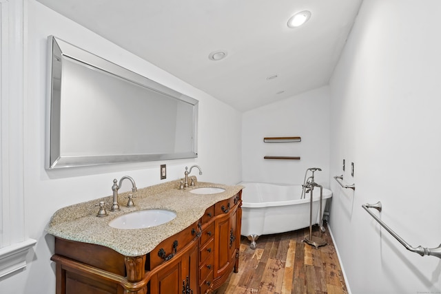 40A Mount Pleasant Rd, Newtown, CT 06470 - bathroom with a soaking tub, wood finished floors, vaulted ceiling, double vanity, and recessed lighting